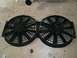 1995 Ford Probe - Two black electric cooling fans are mounted side-by-side on a black bracket, resting on a wooden surface.