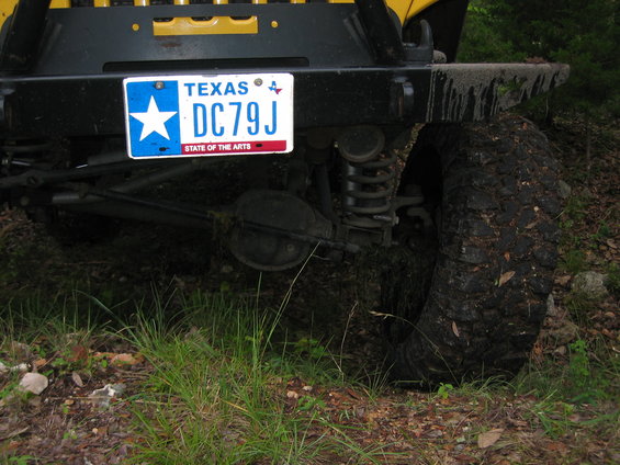 Yellow 2001 Jeep Wrangler rear bumper and tire with Texas license plate