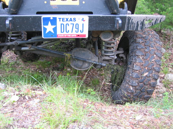 2001 Jeep Wrangler rear axle, suspension, and tire with Texas license plate