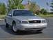 2002 Ford Crown Victoria - A silver 2002 Ford Crown Victoria is shown from the front three-quarter view on a sunny day.