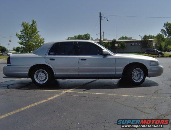 Silver 2002 Ford Crown Victoria parked on asphalt, side view