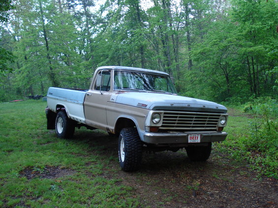 1967 Ford F-250 pickup truck parked in a wooded area