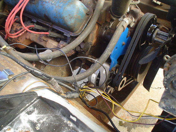 Engine bay wiring with blue bracket and belts