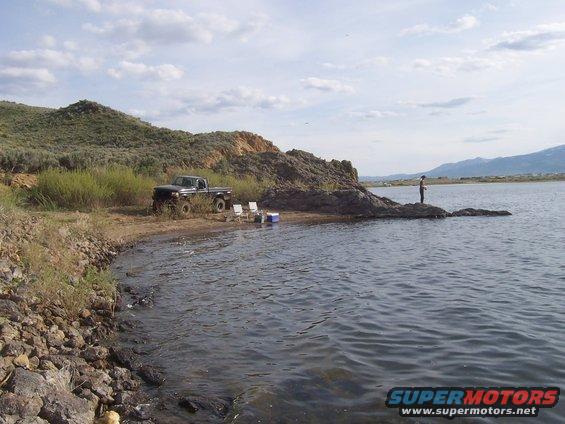 Ford F-150 parked near a lake with a person fishing
