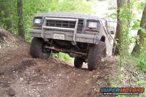 Ford F-250 on a dirt trail, front end angled up a hill. License plate reads B596 YN