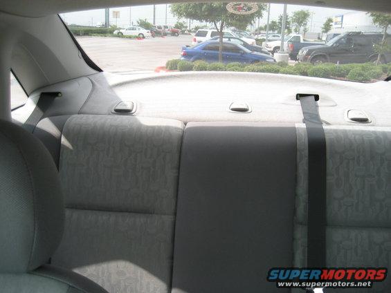 Interior rear seats looking out at a parking lot with several cars