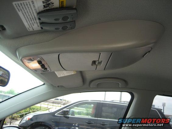 overhead console with lights and storage, view out window shows another car