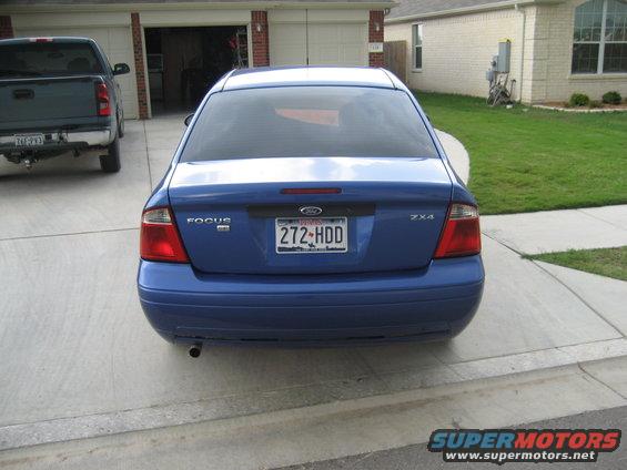 Blue Ford Focus sedan rear view with license plate 272-HDD