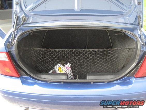 blue car trunk with cargo net holding some items