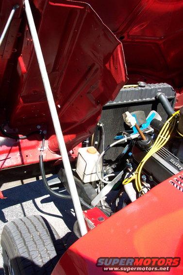 Red engine bay with Holley carburetor and yellow spark plug wires