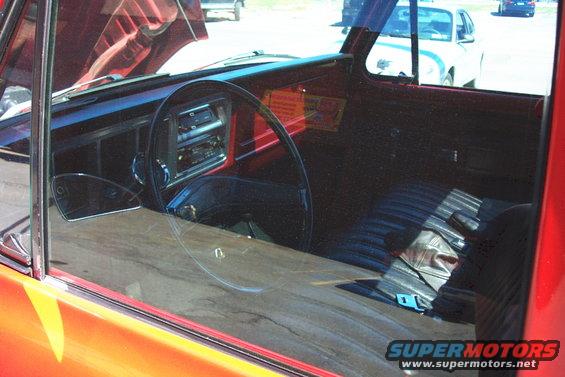 Red truck interior with aftermarket radio and black seats