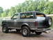 1989 Ford Bronco - This 1989 Ford Bronco is parked on a dirt and gravel area next to a river.