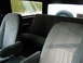 1989 Ford Bronco - The interior of a Ford Bronco shows fabric seats and a spare tire mounted in the back.