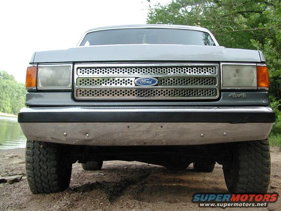 Gray 1987 Ford Bronco front grille and bumper, with "4x4" badge visible