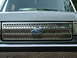 1989 Ford Bronco - Close-up of the 1989 Ford Bronco's distinctive front grille and Ford emblem.