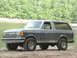 1989 Ford Bronco - This two-tone gray Ford Bronco, likely from the late 1980s, is shown from a three-quarter front angle near a body of water.