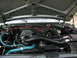 1989 Ford Bronco - The engine bay of a vehicle, showing the V8 engine and various hoses and components.