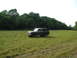 1989 Ford Bronco - 1989 Ford Bronco sits in an open field under a bright sky.