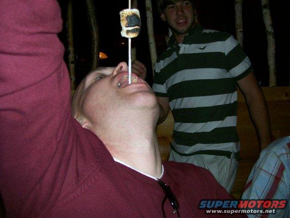 People roasting marshmallows over a fire
