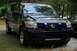 2007 Nissan Titan - Front view of a dark blue Nissan Titan pickup truck parked on a grassy area.