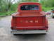 1965 Ford F-100 - This red Ford pickup truck shows its rear end, with the iconic 'FORD' lettering on the tailgate.