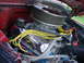 1965 Ford F-100 - Close-up view of the engine compartment of a 1965 Ford F-100, highlighting its V8 engine components.