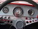 1965 Ford F-100 - The interior of a 1965 Ford F-100 shows its "Custom Cab" dashboard with various gauges and a distinctive steering wheel.