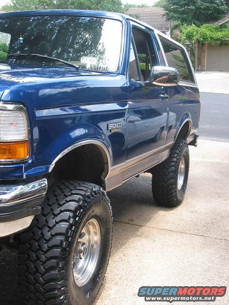 Blue 1996 Ford Bronco with lifted suspension and large tires