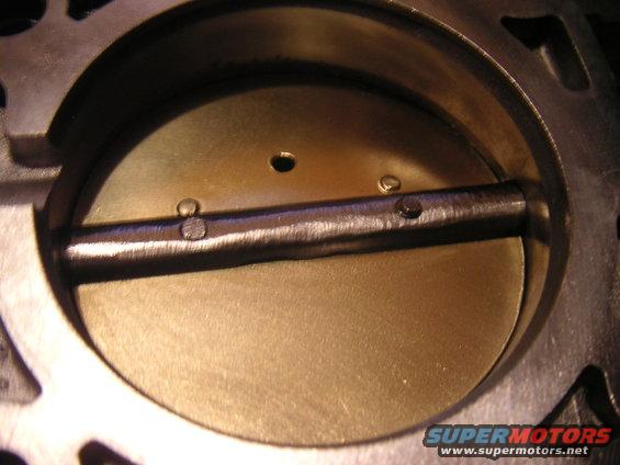 Close-up of a throttle body interior with the butterfly valve closed