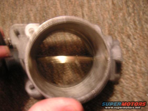 Close-up of a throttle body with the butterfly valve visible