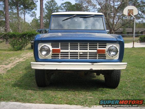 Front view of a blue and white first-generation Ford Bronco with a white grille