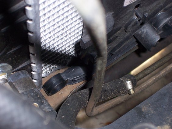 close-up of a black plastic clip holding a fan shroud to a radiator