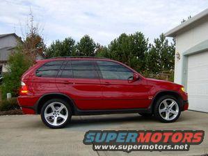 Red SUV parked in front of a garage