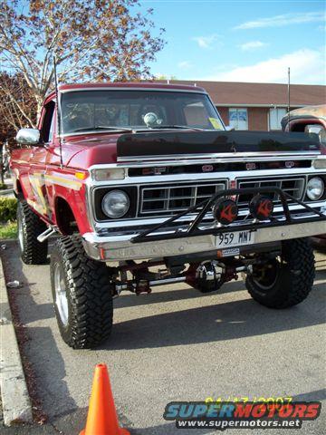 Red 1976 Ford F-250 with custom grille guard and lifted suspension