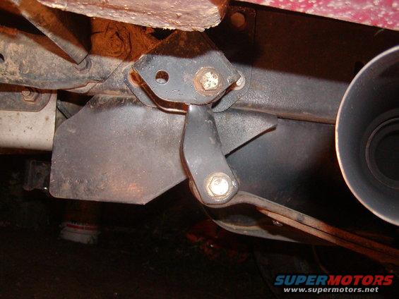 close-up of vehicle's rear suspension shackle and exhaust pipe