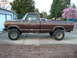 1978 Ford F-250 - Side profile of a lifted 1978 Ford F-250 pickup truck parked on a driveway.