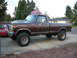 1978 Ford F-250 - A lifted 1978 Ford F-250 pickup truck is parked on a concrete driveway in front of a house.