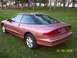 1996 Ford Probe - A 1996 Ford Probe is parked on a grassy lawn with trees in the background.