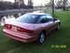 1996 Ford Probe - Rear view of a 1996 Ford Probe in a grassy, outdoor setting.