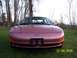 1996 Ford Probe - A pink Ford Probe is shown from the front, parked outdoors on a grassy area with trees.