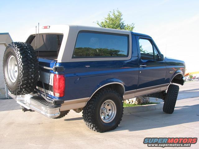 Blue 1996 Ford Bronco with lifted suspension and spare tire