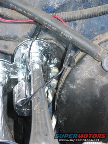 Chrome train horn assembly with visible wiring and a black hose with DOT text