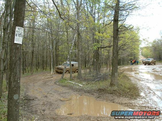1991 Ford Bronco on a muddy forest trail
