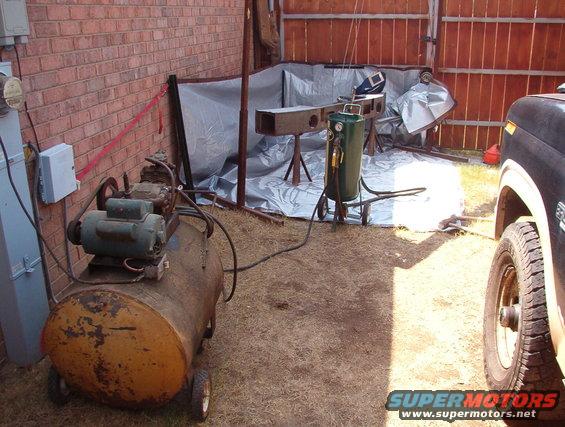 blastsetup.jpg Because the price of sand is rising fast, and I have to drive pretty far to get it, I decided to try to reuse it by catching it in a tarp.  It worked - I was able to recover more than 90% of the sand & filter it thru a screen to remove the grass that blew onto the tarp.