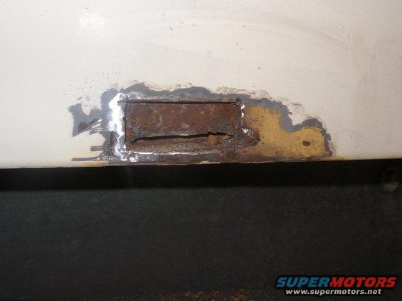 Bottom right almost in the corner. I cut out a small hole about 2 in long by 1 in tall. I see lots of rust. I think I will have to cut most of the bottom piece out. 