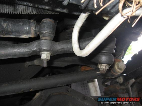 Close-up of a vehicle's steering linkage with tie rod ends and ball joints visible