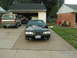 1988 Ford Mustang - A black Ford Mustang is parked in a driveway next to a Ford Bronco.