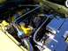 2002 Ford Mustang - Customized engine bay chrome and yellow accents, likely a performance modification.