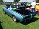 2002 Ford Mustang - A light blue 1969 Pontiac Grand Prix convertible is displayed with its hood open at an outdoor car show.