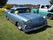 2002 Ford Mustang - A light blue 1958 Chevrolet Bel Air is parked on grass next to other vehicles.